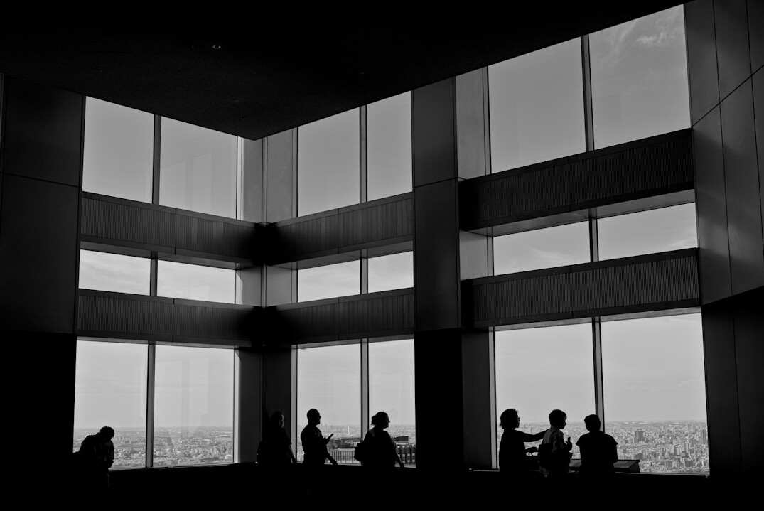 Small group of business leaders in an informal discussion near a window
